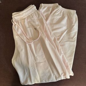Light pink sweatpants. Light weight material. Gathered at the ankle.